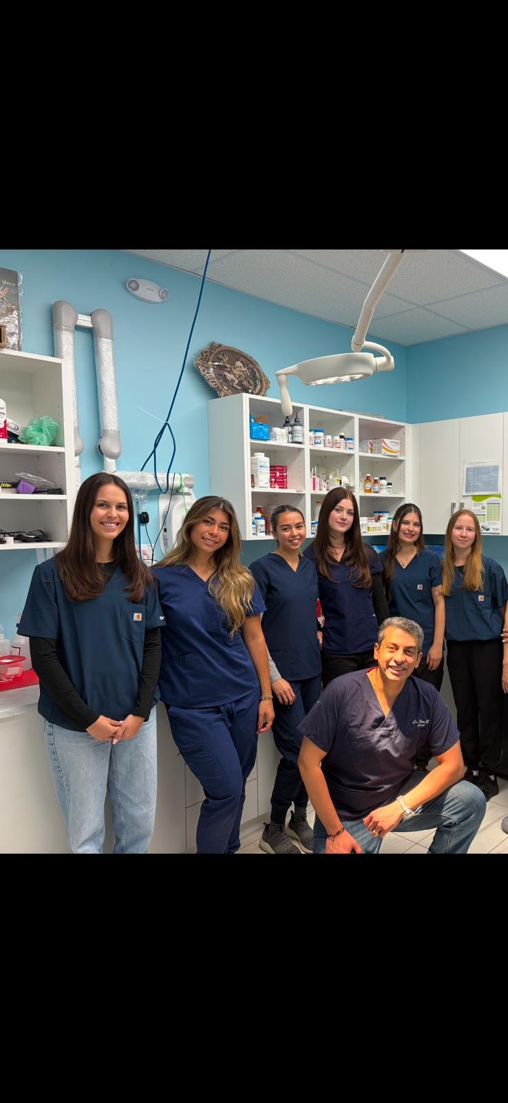 The St. George Animal Hospital team with Dr. Peter in the treatment room